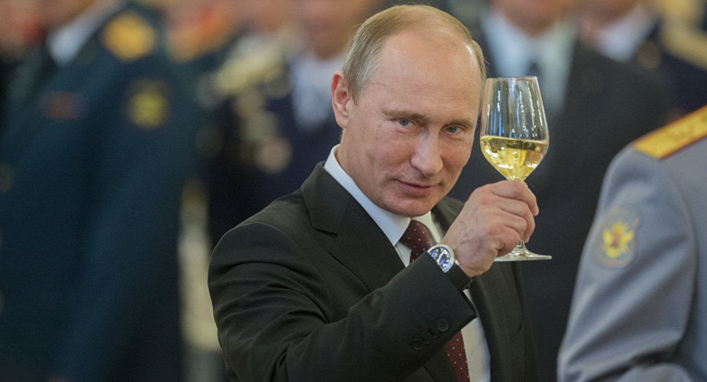 Vladimir Putin lifting a glass of white wine.