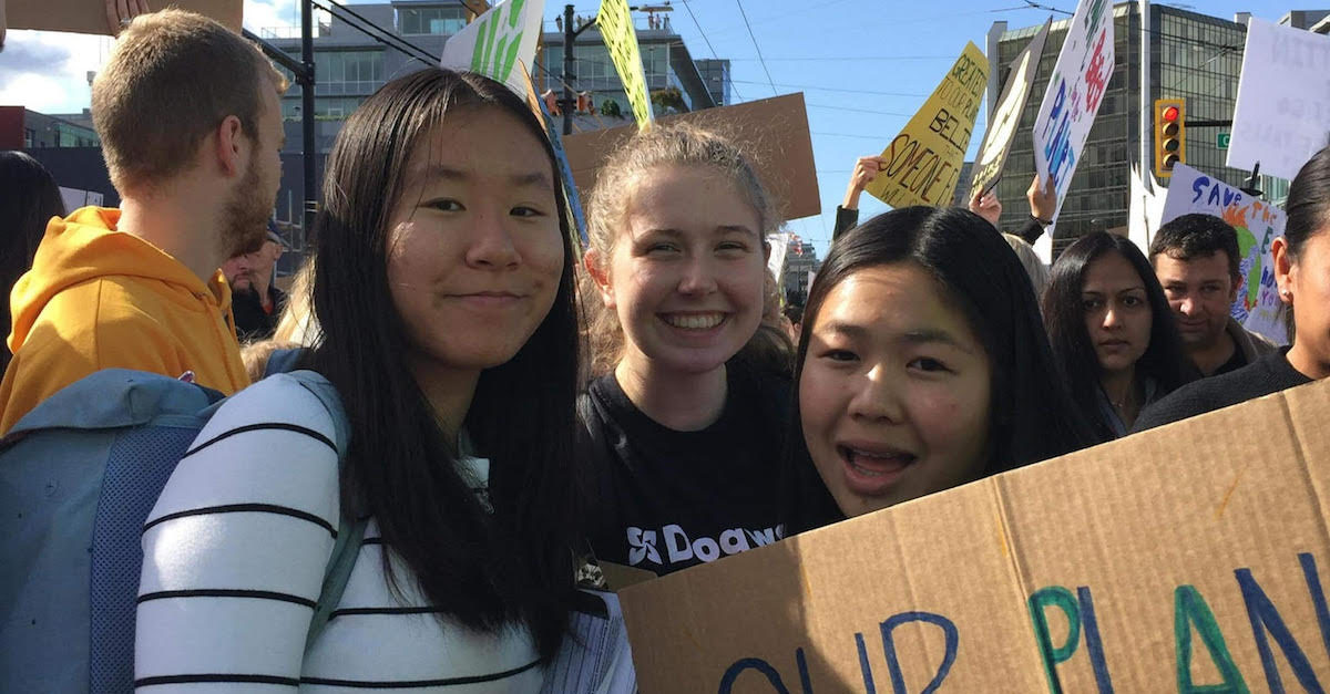 Three teens at a climate rally