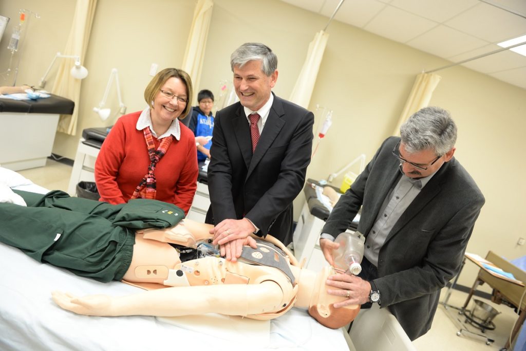 BC Liberal leader Andrew Wilkinson with a medical dummy