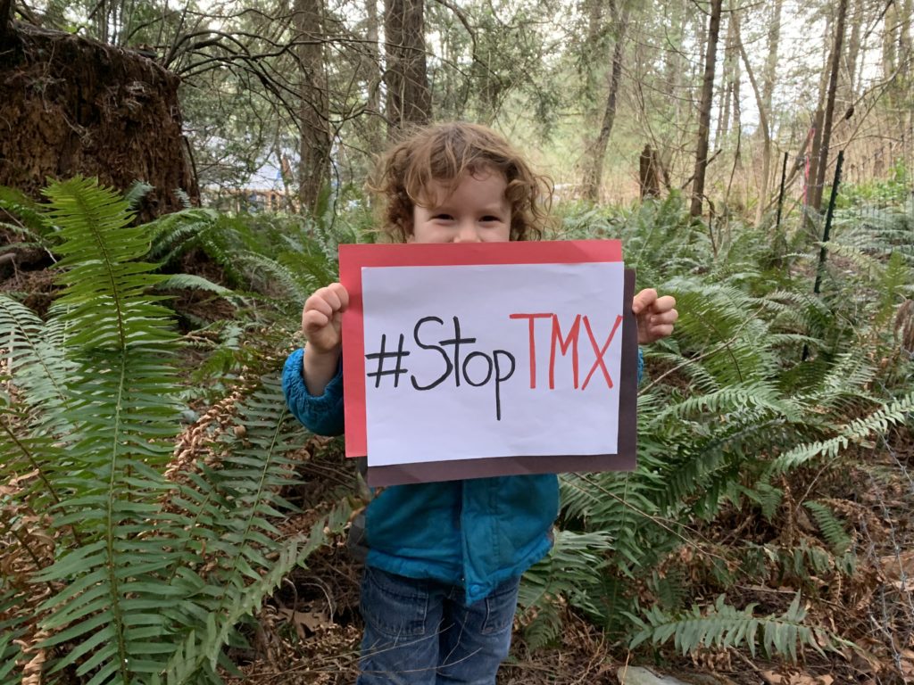 Kid holds #StopTMX sign